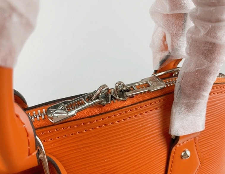 Louis Vuitton Epi Leather Alma PM Handbag In Orange With Jacquard Strap