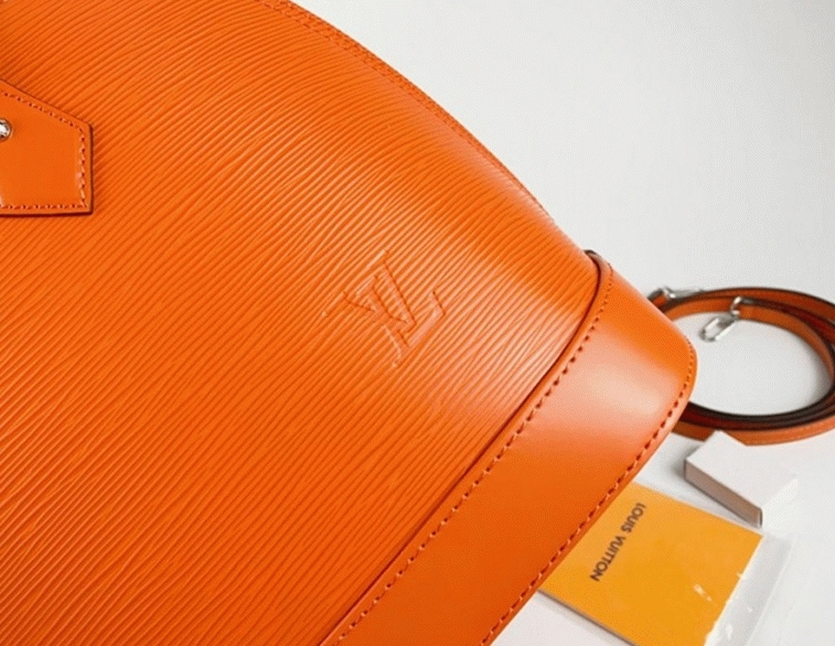 Louis Vuitton Epi Leather Alma PM Handbag In Orange With Jacquard Strap