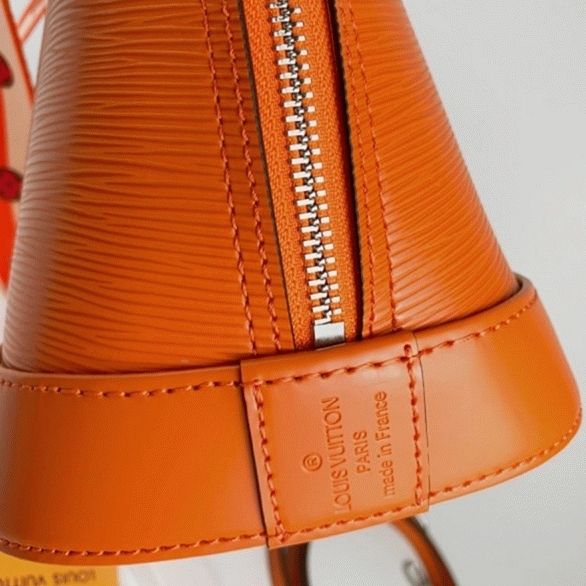 Louis Vuitton Epi Leather Alma PM Handbag In Orange With Jacquard Strap