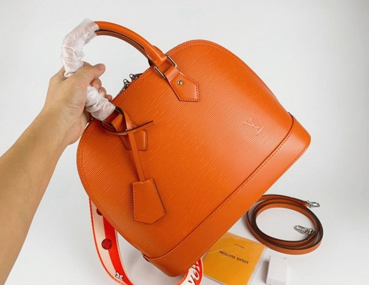 Louis Vuitton Epi Leather Alma PM Handbag In Orange With Jacquard Strap