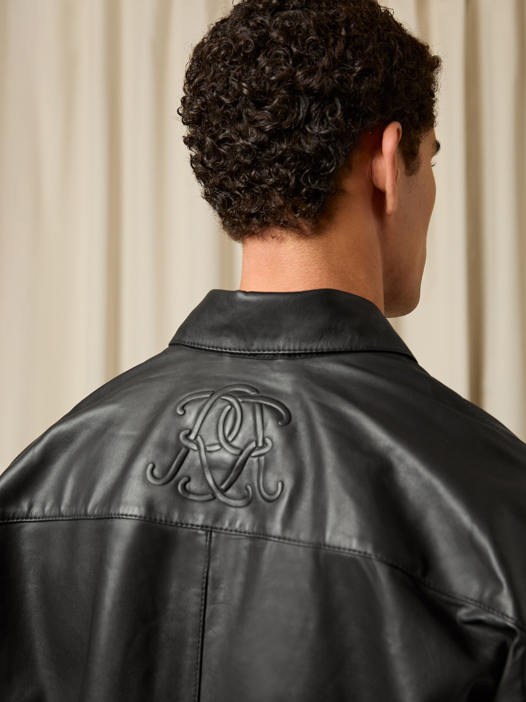 Monogram Embossed Leather Jacket in Black