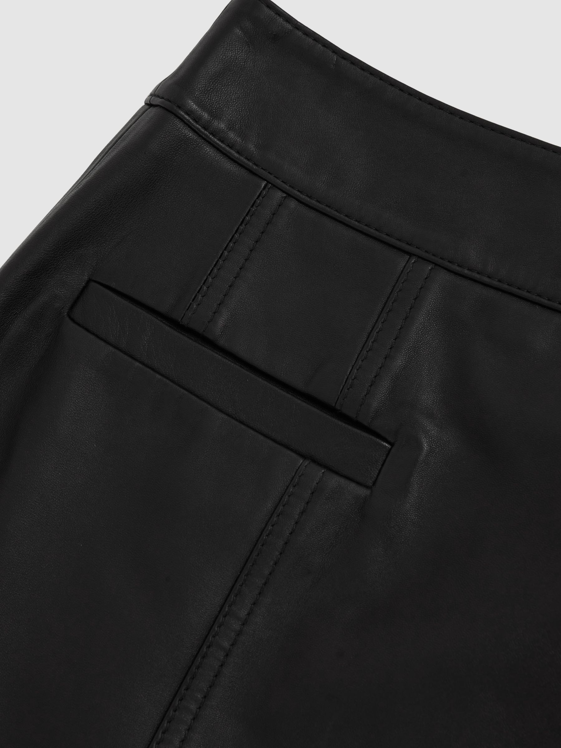 Leather Welt-Pocket Mini Skirt in Black